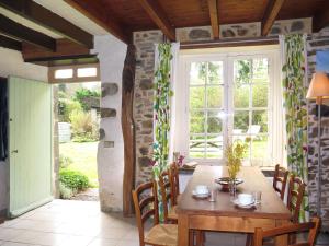 een eetkamer met een tafel en een raam bij Holiday Home Gîte des Oiseaux by Interhome in Plouha