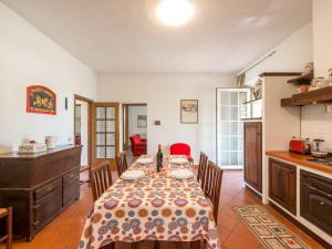 a kitchen and dining room with a table and chairs at Holiday Home Podere Chiocciolaia by Interhome in Podere Cernaia