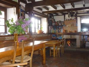 a dining room with a table and chairs and a fireplace at Posada Torcaz in Cahecho