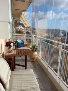 a balcony with a table and a view of the city at Suite Estasi in Naples