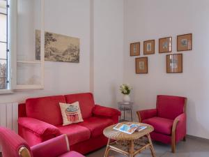 salon z czerwoną kanapą i 2 krzesłami w obiekcie Villa Anita by Interhome w mieście Marina di Pietrasanta