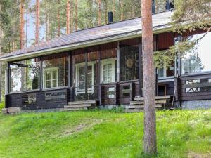 a wooden house in the middle of a forest at Holiday Home Luppo-koli - laferte 1 by Interhome in Kolinkylä