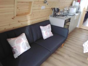 a couch with two pillows on it in a kitchen at Glamping Pods in Cromer
