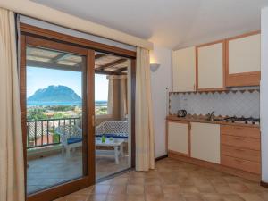 a kitchen with a view of a mountain at Holiday Home Corbezzolo 9 - Vista Village by Interhome in Porto San Paolo