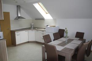 a kitchen with a table and chairs in a room at 238 Spodnje Gorje in Spodnje Gorje