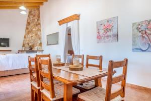 a dining room with a table and chairs and a bed at Can grau petit in Sencelles