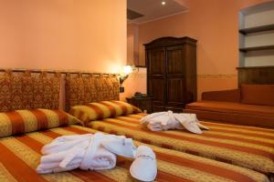Postel nebo postele na pokoji v ubytování Hotel Belle Epoque