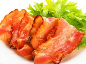 a close up of a piece of food on a plate with greens at Hotel Ace Morioka in Morioka +55 photos