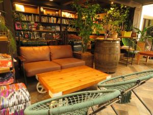 a living room with a couch and a table at Hostel Cuore Kurashiki in Kurashiki