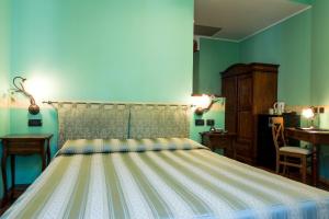 Postel nebo postele na pokoji v ubytování Hotel Belle Epoque