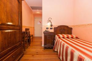 Postel nebo postele na pokoji v ubytování Hotel Belle Epoque