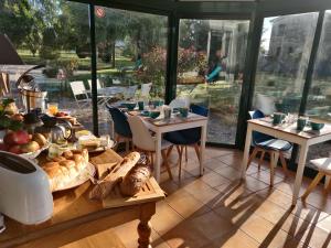 a table with food on it in a restaurant at Les fleurs du Mont in Céaux +39 photos