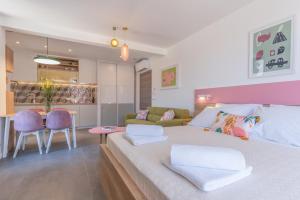 a bedroom with a large bed and a living room at Apartments Olea in Cavtat