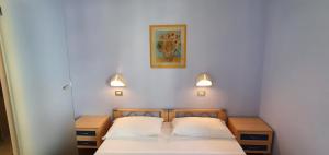Rúm í herbergi á Hotel Sud Est by Fam Rossetti