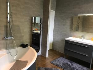 a bathroom with a bath tub and a sink at Château du Puech in Curières