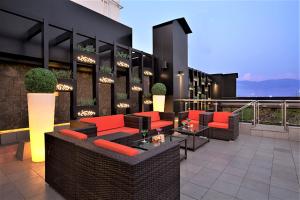 a patio with red chairs and tables on a building at Yogi Executive, Navi Mumbai in Navi Mumbai