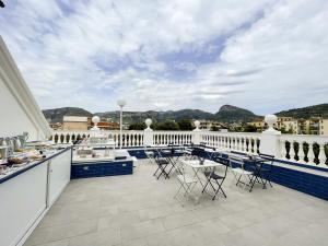 a balcony with tables and chairs on a building at Villa Gabriella - Rooms & Breakfast in Sant'Agnello