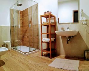 a bathroom with a shower and a sink at Le Bifore in valle in Predazzo