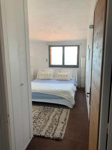 a bedroom with a bed and a window at La Gavaresse in Carqueiranne