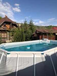 a swimming pool on top of a house at Country house Fuzhn "Будиночок гедоніста" in Tukhlya