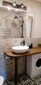 a bathroom with a sink and a washing machine at Vintage Rooms in Kuldīga
