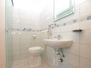 a white bathroom with a toilet and a sink at House Mario 1931 in Banjole +29 photos