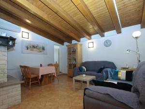 a living room with two couches and a table at House Mario 1931 in Banjole