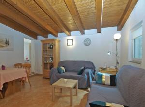 a living room with a couch and a table at House Mario 1931 in Banjole