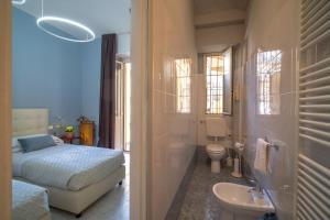 a bedroom with a bed and a sink and a toilet at Hotel Italia in Turin +30 photos