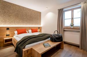 a bedroom with a large bed and a window at Alperie Ferienhaus in Schliersee