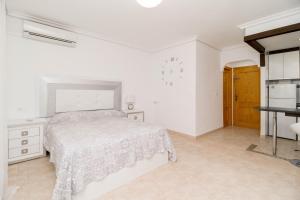 a white bedroom with a bed and a table at La Mata Bélgica in La Mata +17 photos