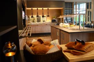 a kitchen with a basket of bread on a table at Zefyr Hotel in Bodø