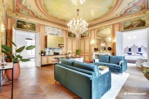 a living room with blue furniture and a ceiling at CMG Malesherbes in Paris