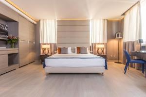 a hotel room with a bed and a desk and a desk at Orazio Palace Hotel in Rome