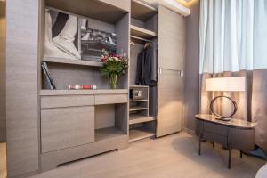 a walk in closet with a table and a lamp at Orazio Palace Hotel in Rome
