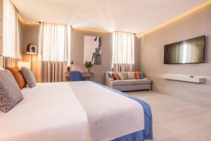 a hotel room with a large bed and a tv at Orazio Palace Hotel in Rome