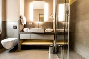 a bathroom with a sink and a toilet and a mirror at Orazio Palace Hotel in Rome