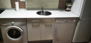 a kitchen with a sink and a washing machine at APARTAMENTO ALES in Arenas de San Pedro +30 photos