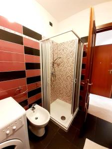 a bathroom with a shower and a toilet and a sink at Clizia Apartment in Alghero