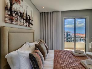 a bedroom with a bed with a large window at Paradise Apartment by LovelyStay in Funchal