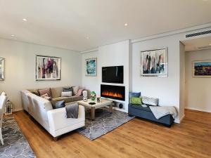 a living room with a couch and a fireplace at Paradise Apartment by LovelyStay in Funchal