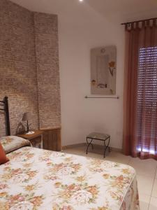 a bedroom with a bed and a table and a window at Casa Rural El Lio in Ruidera