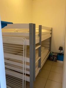 a room with two bunk beds in a room at La bourboule Appartement in La Bourboule