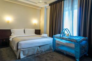 Krevet ili kreveti u jedinici u okviru objekta Royal Palace Hotel