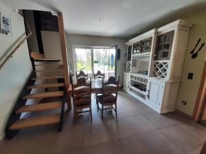 a dining room with a table and chairs and a staircase at Groot GENOEGEN - 50 North in Herne