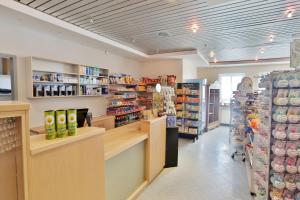 a grocery store aisle with shelves of food at DJH Resort Neuharlingersiel in Neuharlingersiel