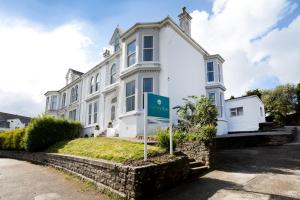a white building with a sign in front of it at Park View in Falmouth