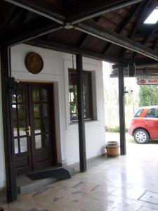 a front door of a house with a car parked at Paprika vendégház in Harkány