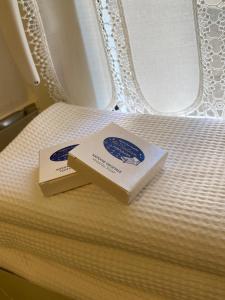 two boxes sitting on top of a bed at Camere Nicolina 4 in Vernazza