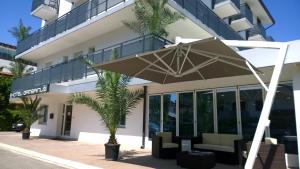 a large umbrella in front of a building at Hotel Gambrinus in Lignano Sabbiadoro